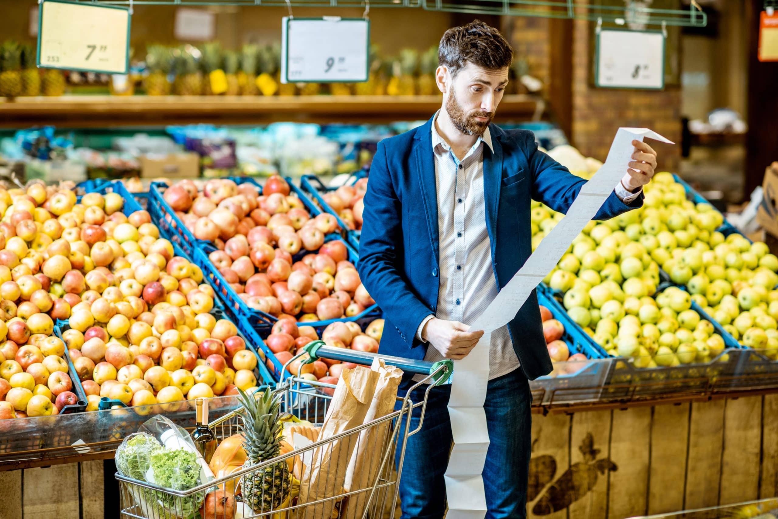 Man with shopping list in the supermarket